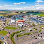 Aerial view of Wester Gourdie Industrial Estate in Dundee showing roundabout, retail units and surrounding commercial area