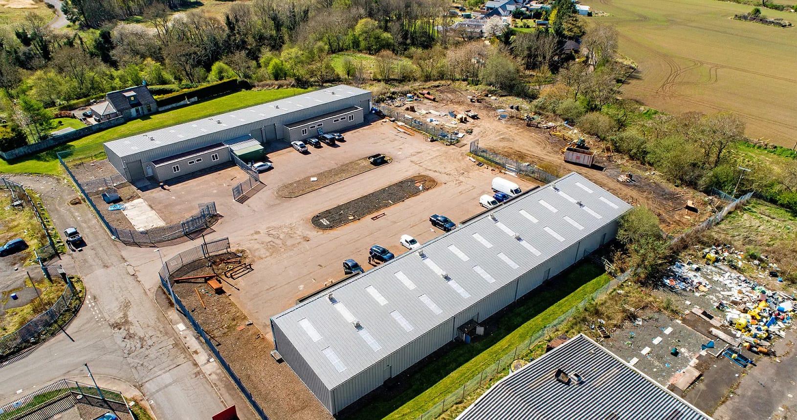 Aerial view of Blocks 11 and 12 at Nobel Road, Wester Gourdie Industrial Estate, showing industrial units, parking areas, and surrounding countryside.
