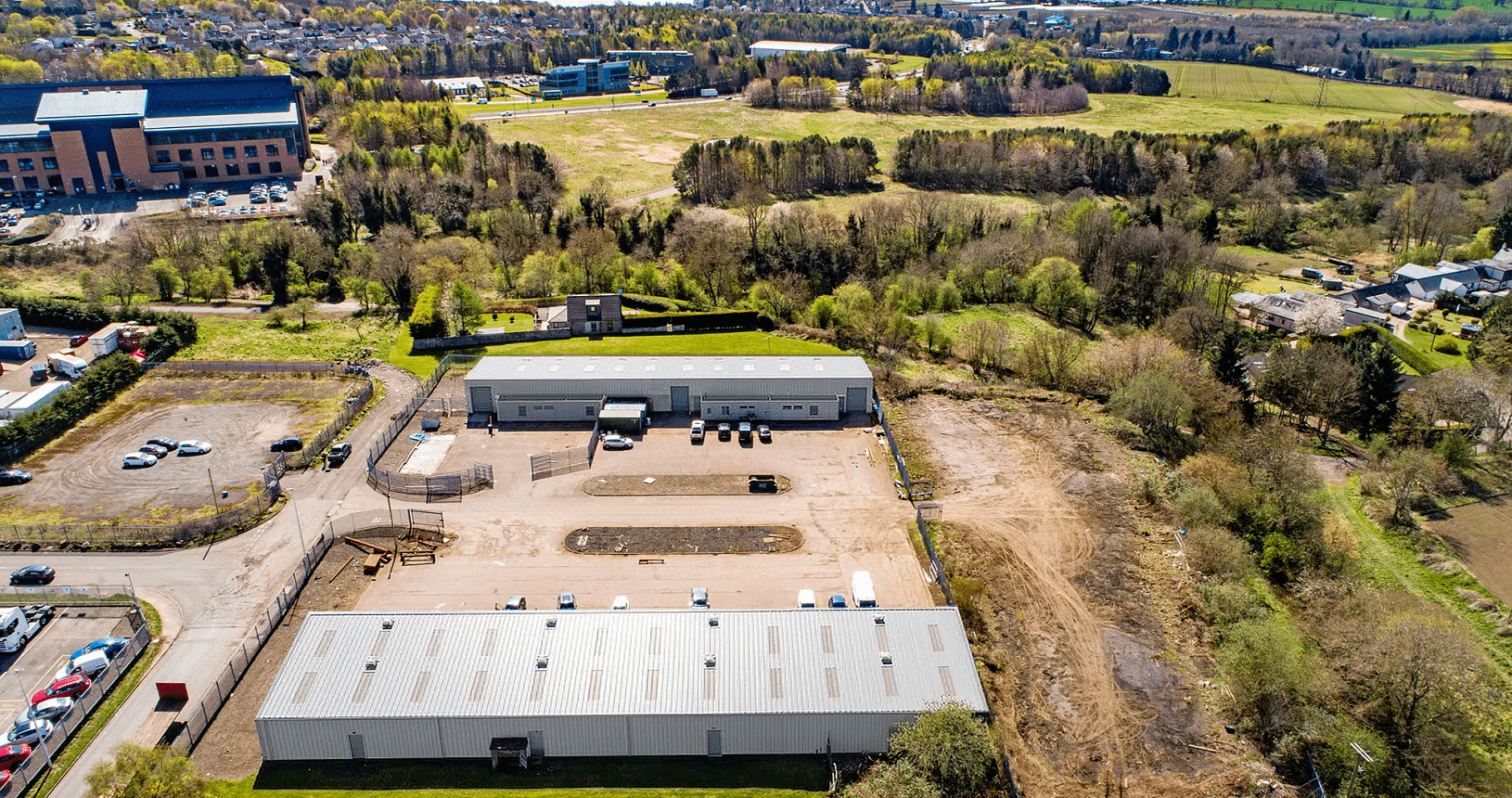 Aerial view of Blocks 11 and 12 at Wester Gourdie Industrial Estate, showing industrial units, yard space and surrounding greenery.