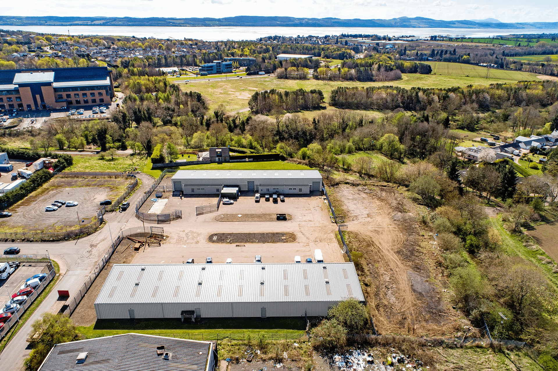 Aerial view of Blocks 11 and 12 at Wester Gourdie Industrial Estate, showing industrial units, yard space and surrounding greenery.