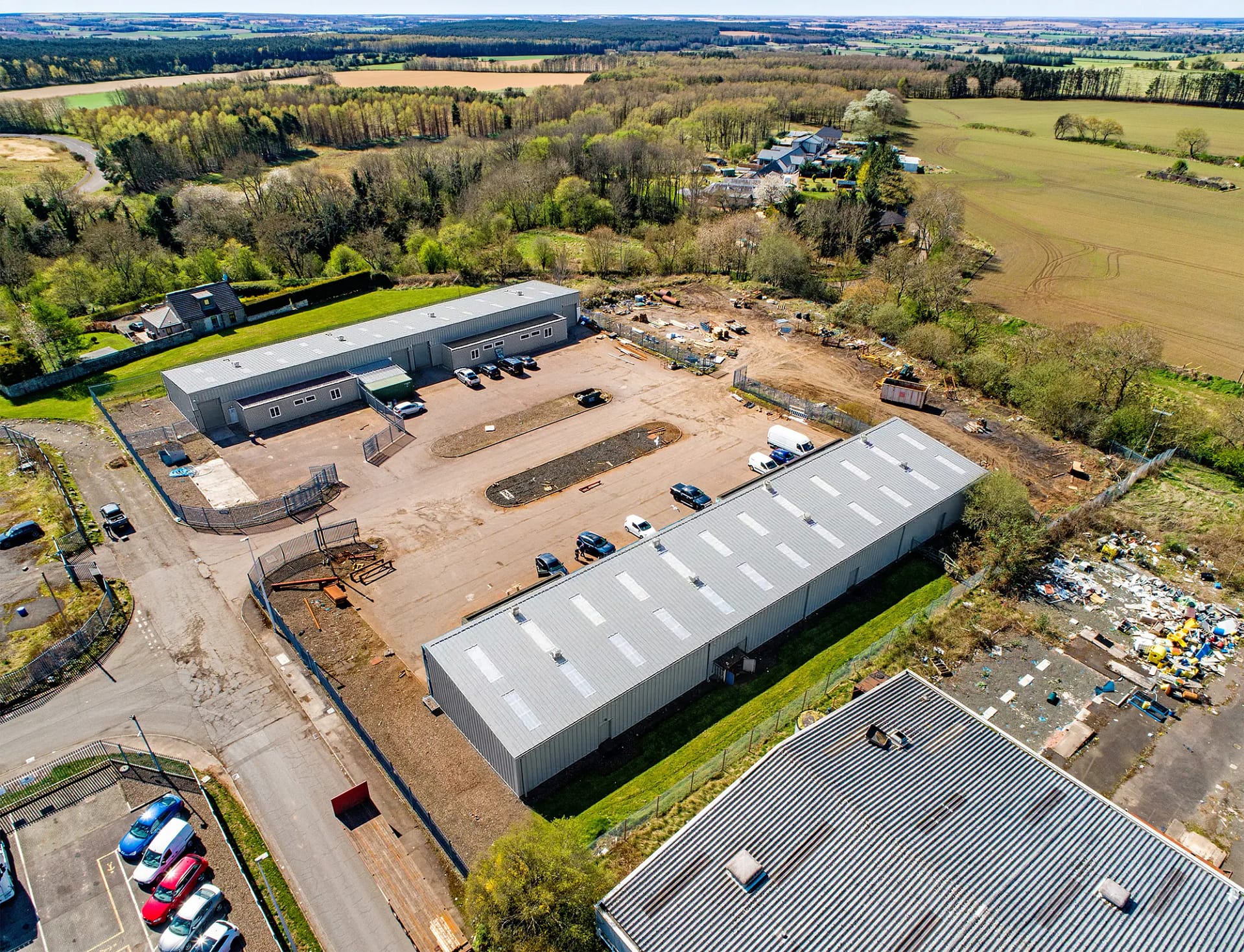 Aerial view of Blocks 11 and 12 at Nobel Road, Wester Gourdie Industrial Estate, showing industrial units, parking areas, and surrounding countryside.