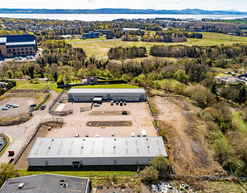 Aerial view of Blocks 11 and 12 at Wester Gourdie Industrial Estate, showing industrial units, yard space and surrounding greenery.